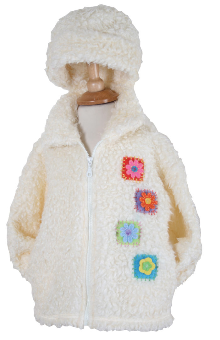white fluffy childrens jacket with flower patches on the side in different colours and matching hat