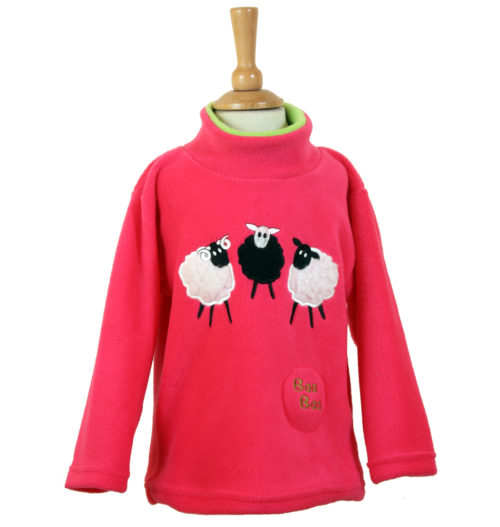 pink fleece for children with three sheep on, two white and one black with a baa baa button