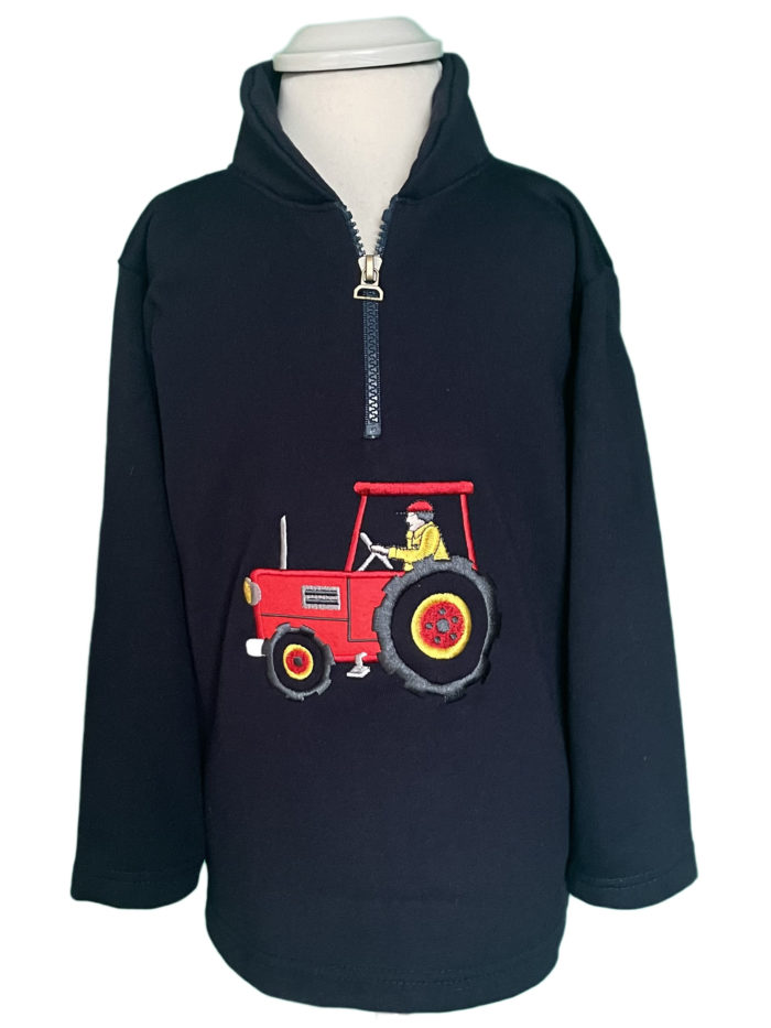 A child's dark navy 1/4 zip fleece with red and yellow tractor.